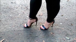 Wife walk on puddles in high heels sandals