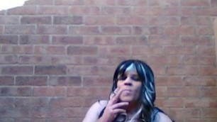 Sissy smoking outdoors in sexy dress